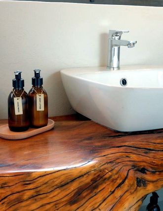 Stone basin on a sleeper-wood counter in a lodge bathroom