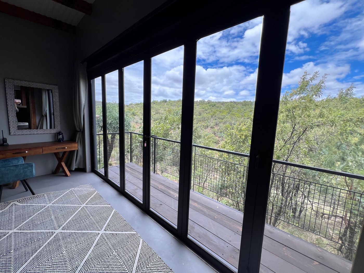 Bedroom with floor-to-ceiling views of the bushveld