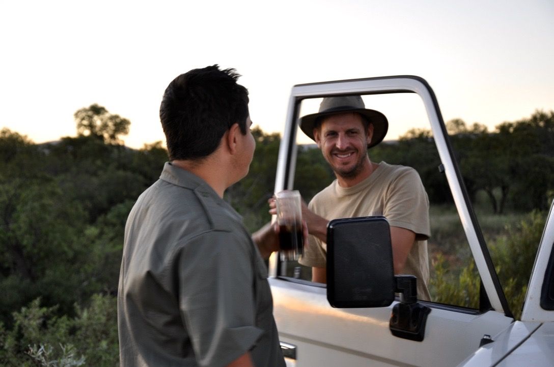 A drink handed to a hunter at the vehicle on a JVZ safari