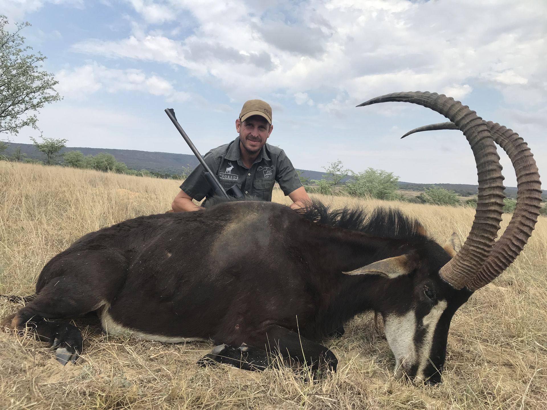 Hunter and professional hunter with a sable bull in Limpopo