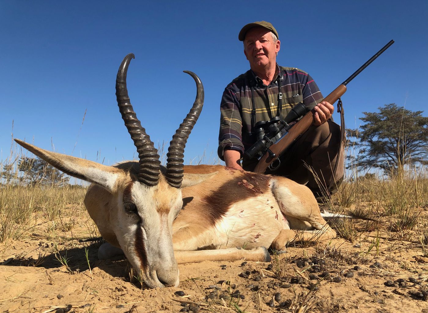 Hunter with a springbok ram